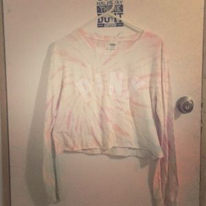 A tie-dyed pink shirt the shirt was made tie-dyed